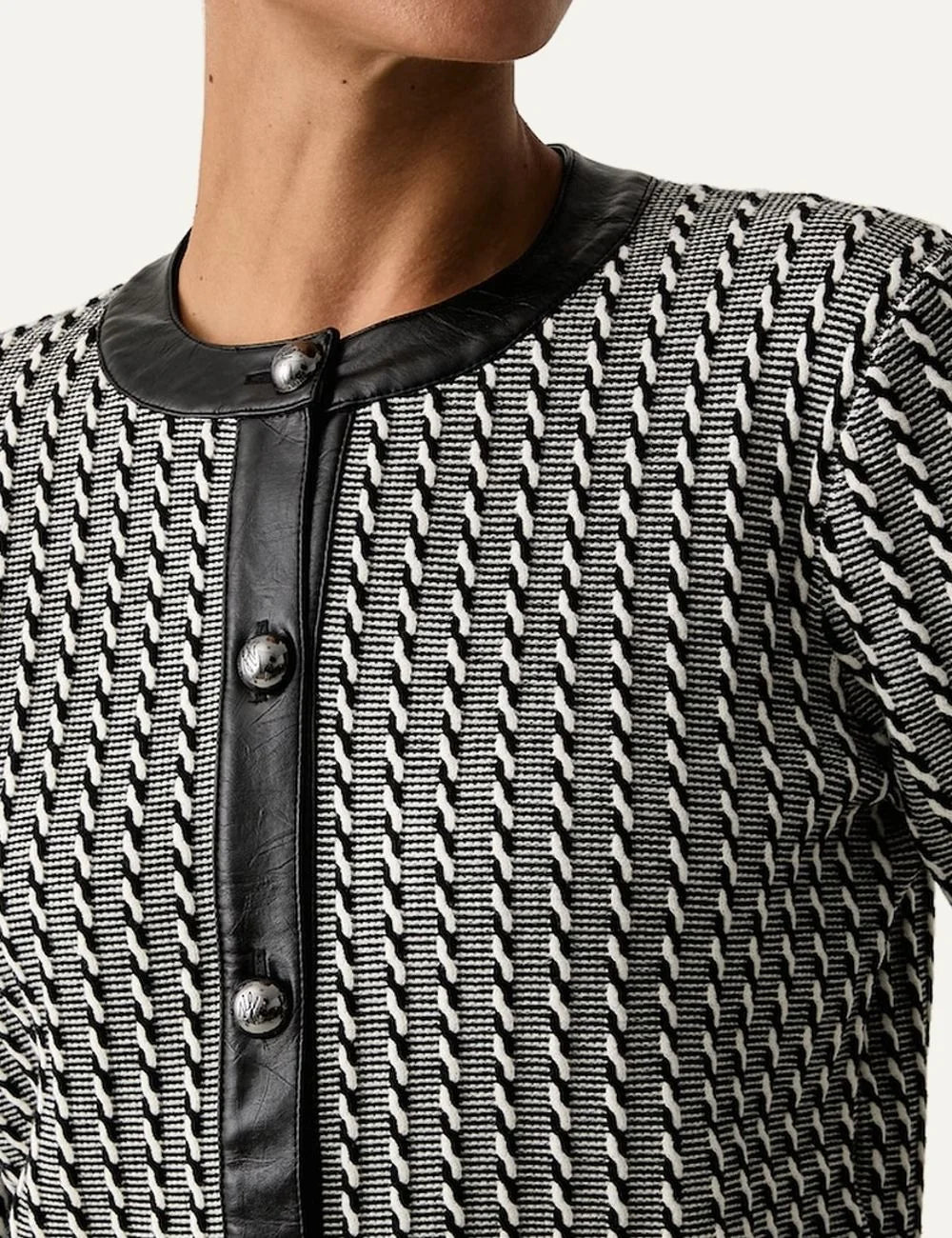 Karl Lagerfeld women's black and white cropped knitted cardigan with geometric stripe pattern, round neckline, metallic buttons and black trim model