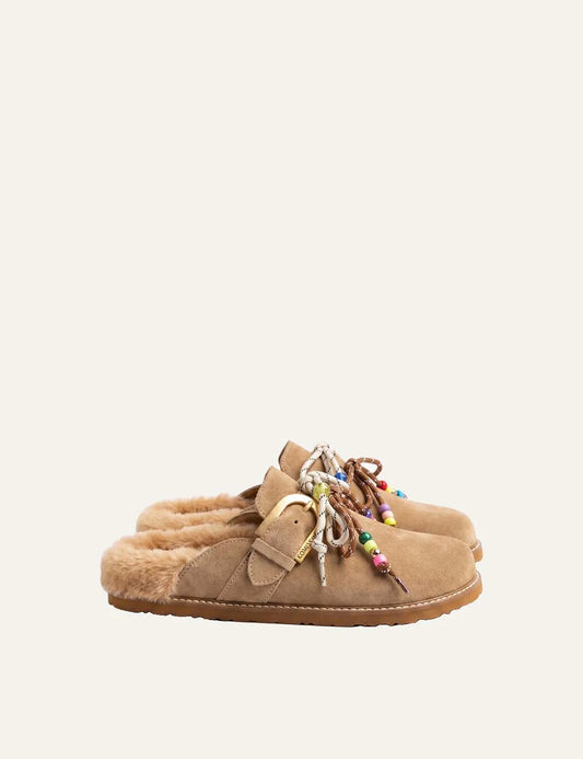 Komis &amp; Komis women's tan suede fur-lined mules with gold buckle.