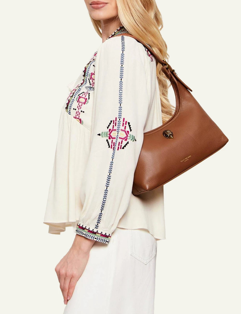 kurt geiger brown leather hobo bag eagle detail buckle strap front model view