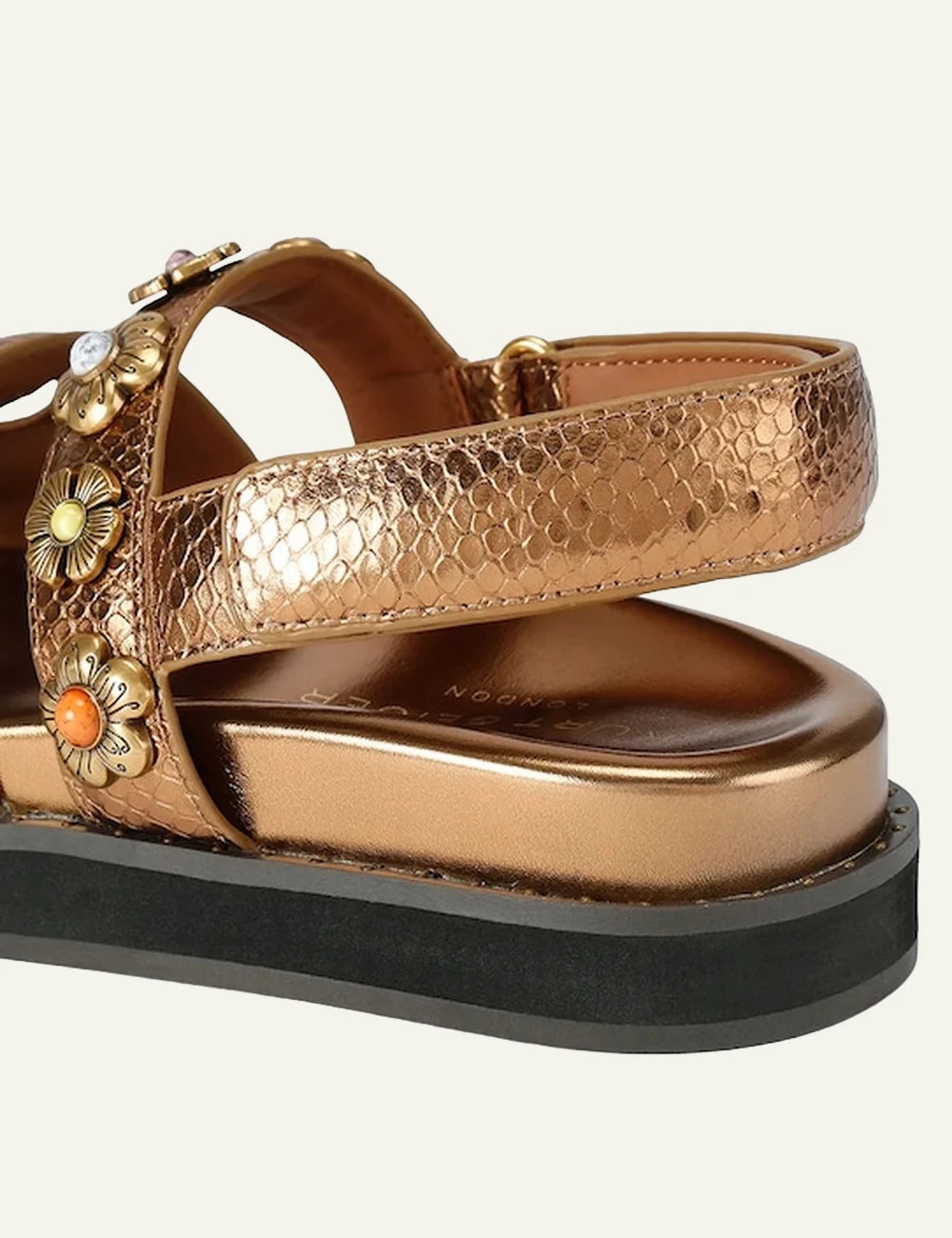 Kurt Geiger gold leather sandal snake texture floral studs eagle logo back view.
