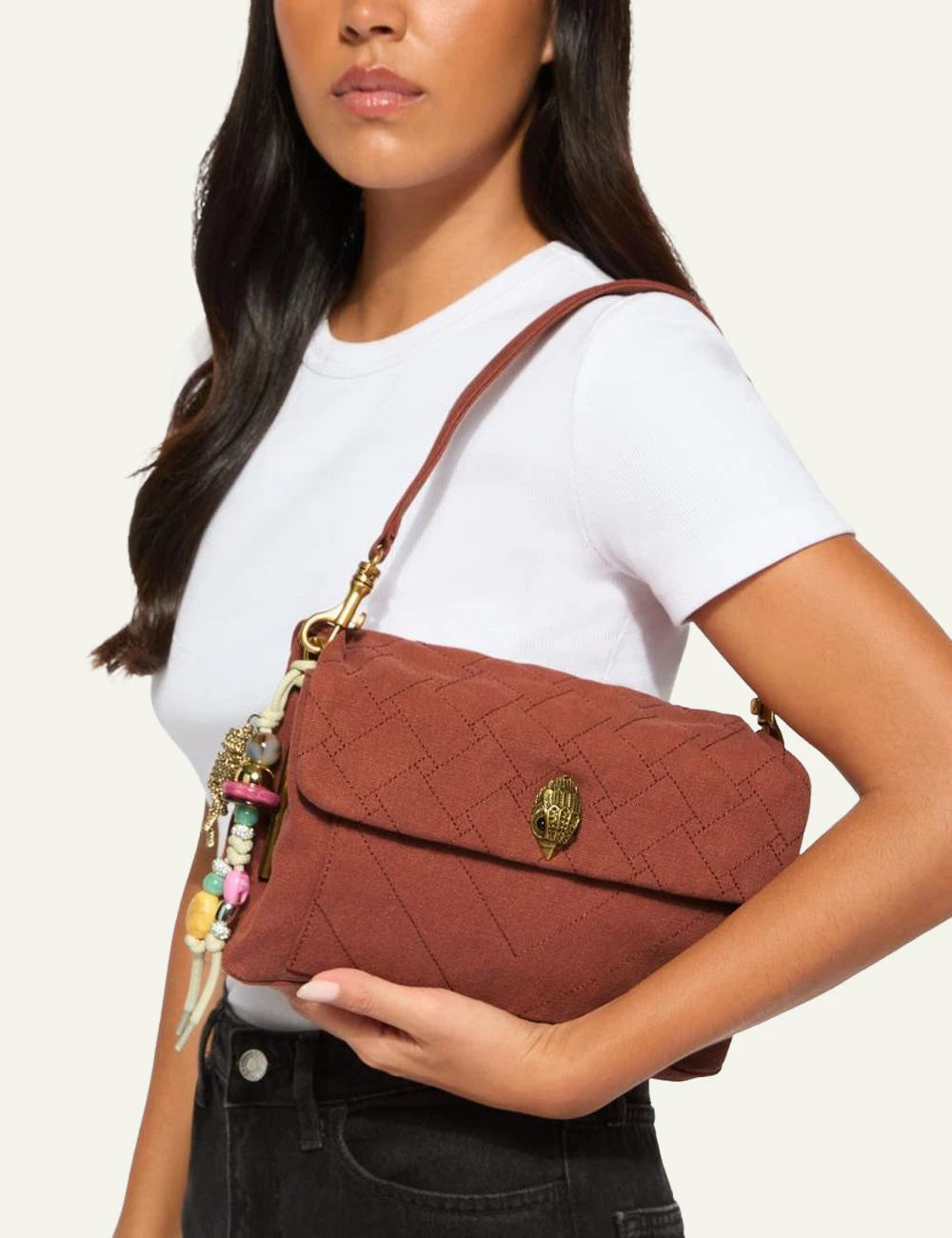 Rust canvas Kurt Geiger shoulder bag with quilted finish, gold chain strap and eagle head clasp model