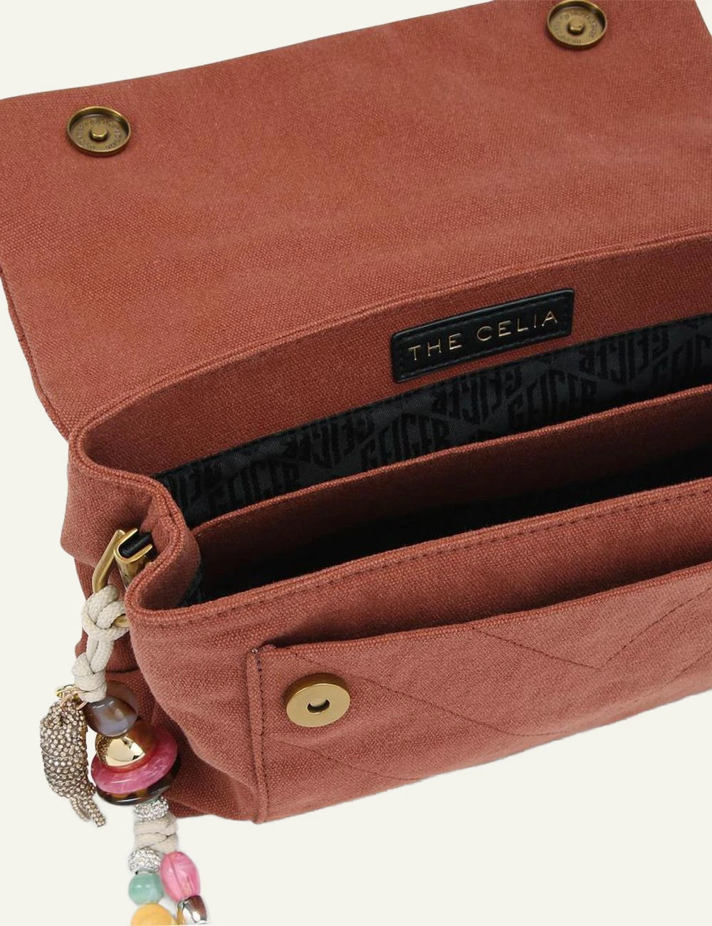 Rust canvas Kurt Geiger shoulder bag with quilted finish, gold chain strap and eagle head clasp top