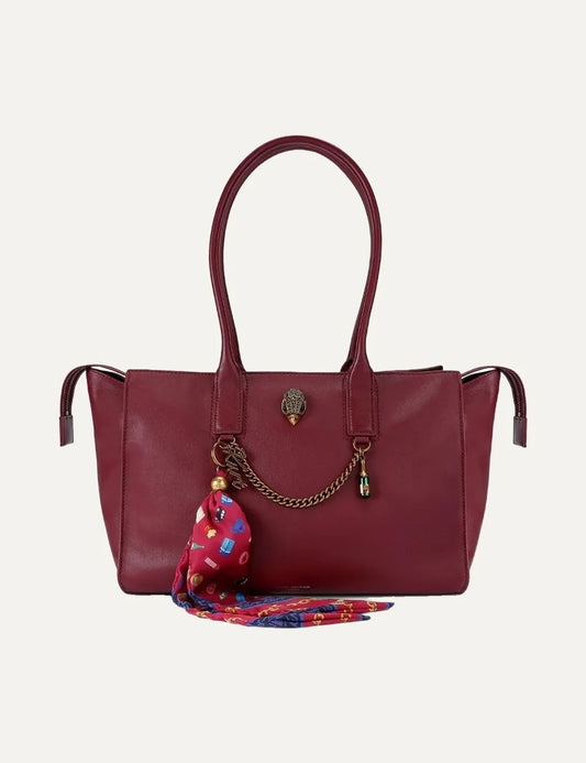 Kurt Geiger women's burgundy red calf leather shoulder tote bag featuring two long top handles, zip top fastening, antique gold-tone chain, crystal embellished eagle head emblem, logo charms and colorful printed scarf detail.