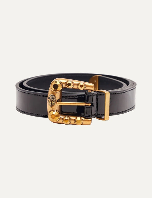 Kurt Geiger women's Maddox black leather belt featuring a glossy finish, an antiqued gold-tone buckle embellished with golden crystals and signature eagle head emblem.