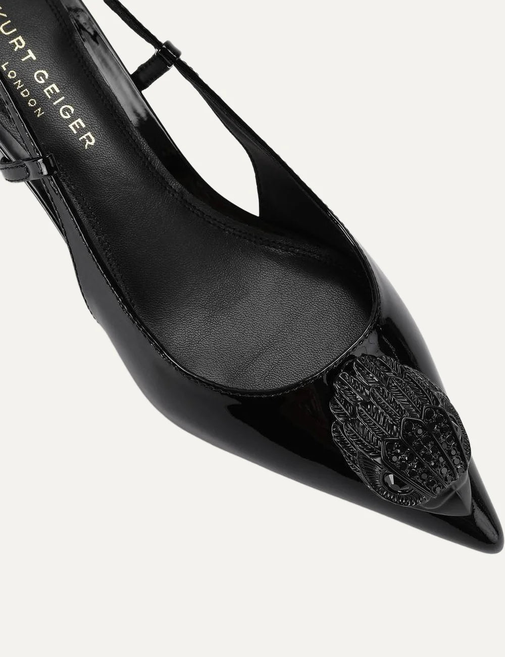 Kurt Geiger London black patent leather slingback pumps with pointed toe, crystal-embellished eagle head, adjustable strap and kitten heelangled