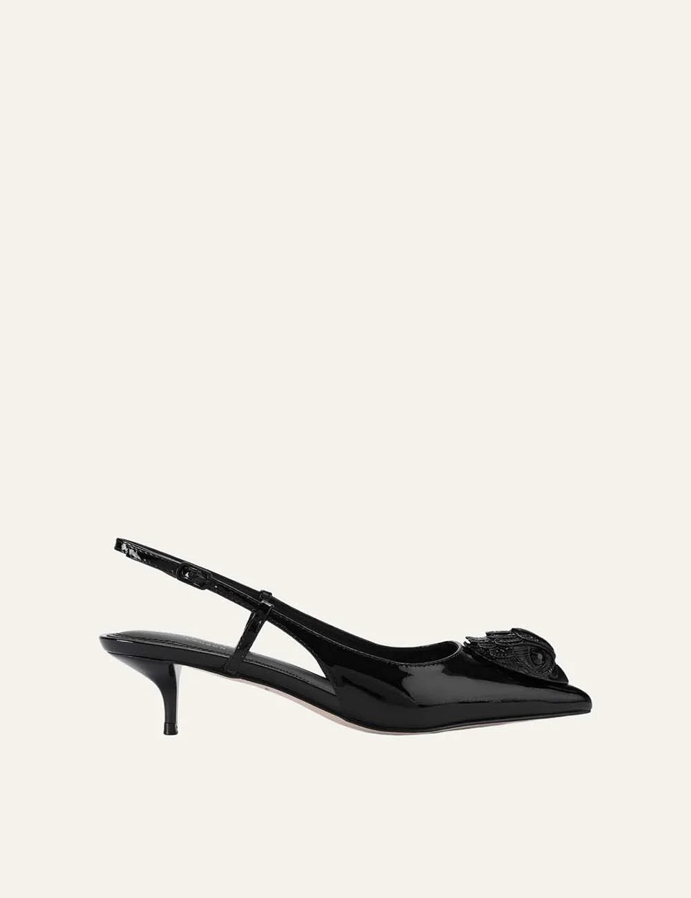 Kurt Geiger London black patent leather slingback pumps with pointed toe, crystal-embellished eagle head, adjustable strap and kitten heel.