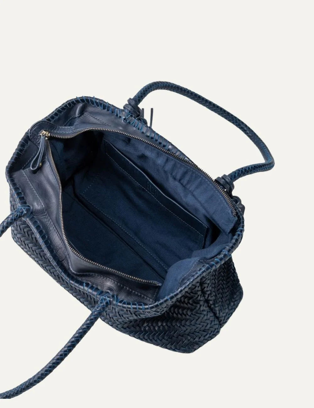 Biba Perkins blue woven leather baguette shoulder bag with elongated silhouette, braided handles, leather tassel and logo tag top
