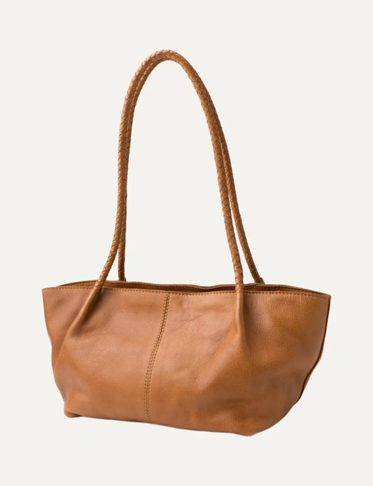 Biba women's tan washed leather baguette shoulder bag with long braided handles, soft curved silhouette and vertical front stitching.