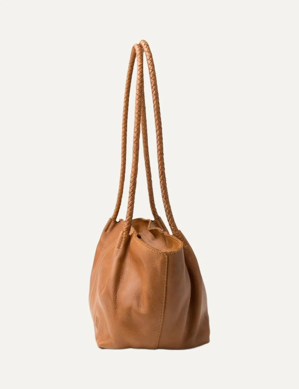Biba women's tan washed leather baguette shoulder bag with long braided handles, soft curved silhouette and vertical front stitching side