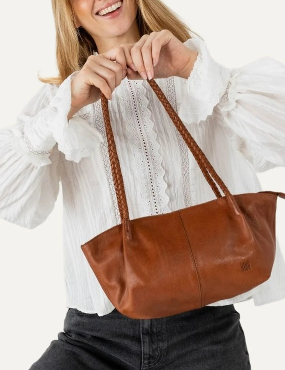 Biba women's tan washed leather baguette shoulder bag with long braided handles, soft curved silhouette and vertical front stitching model