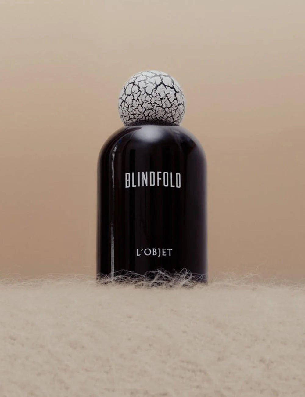 L'Objet Blindfold fragrance black bottle cracked cap front detail view
