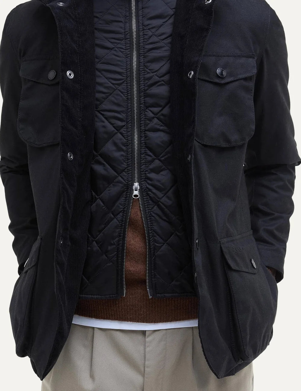 Men's Barbour Ogston black heavyweight waxed cotton jacket with quilted inner vest, stand collar, four utility pockets and leather elbow patches inside details