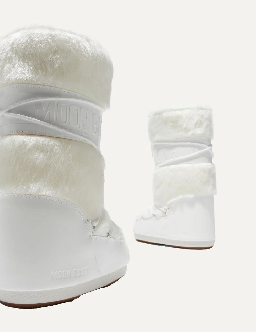 Moon Boot women Icon white faux fur boots with criss-cross laces and logo details pair details