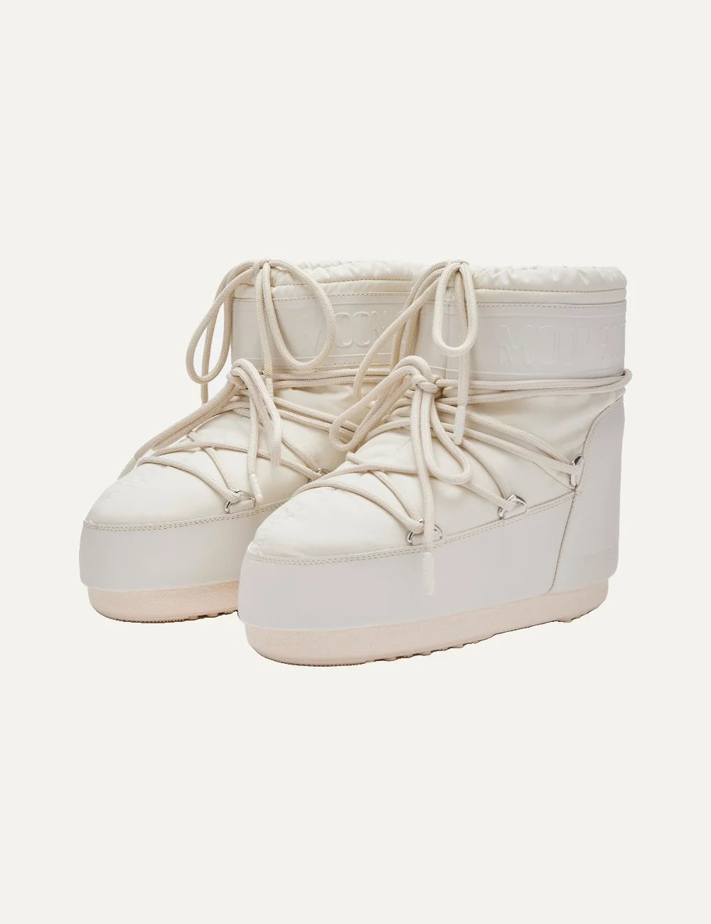 Moon Boot women Icon Low cream rubber boots with criss-cross laces and embossed logo details front angle view