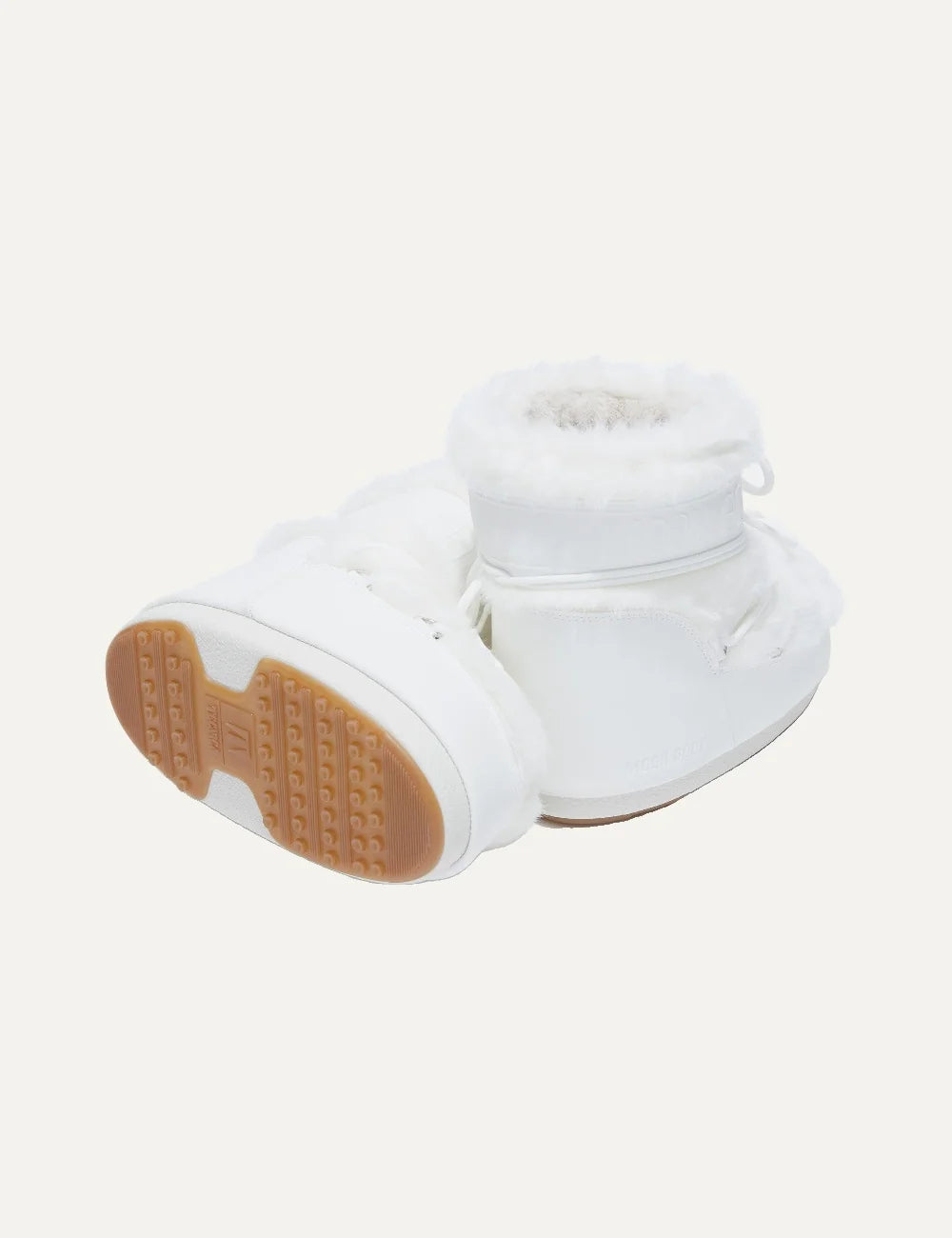 Moon Boot women Icon Low white faux fur boots with criss-cross laces and logo details sole view