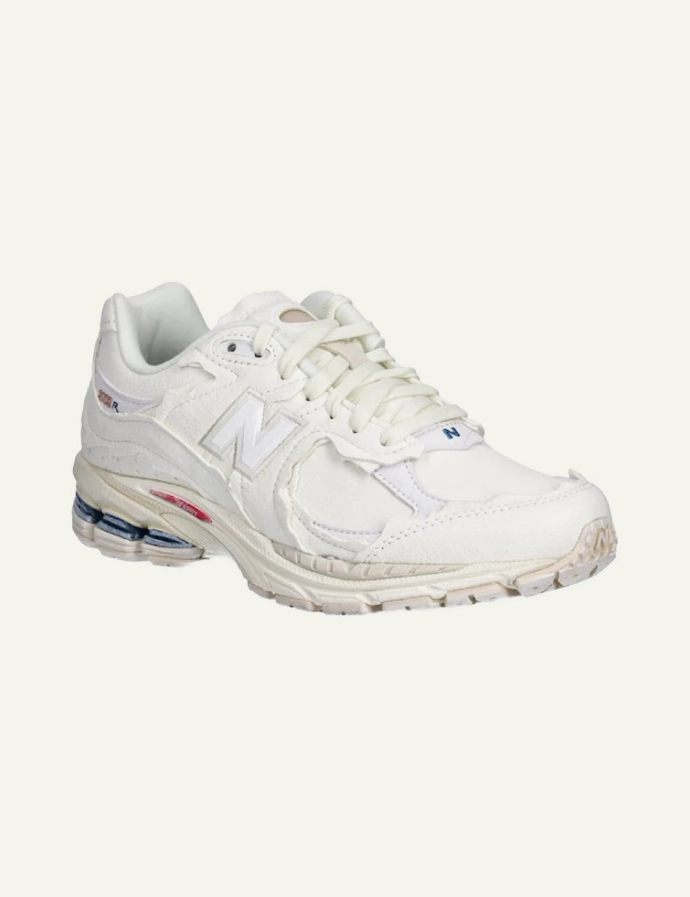 New Balance 2002R beige leather dad sneakers angled view