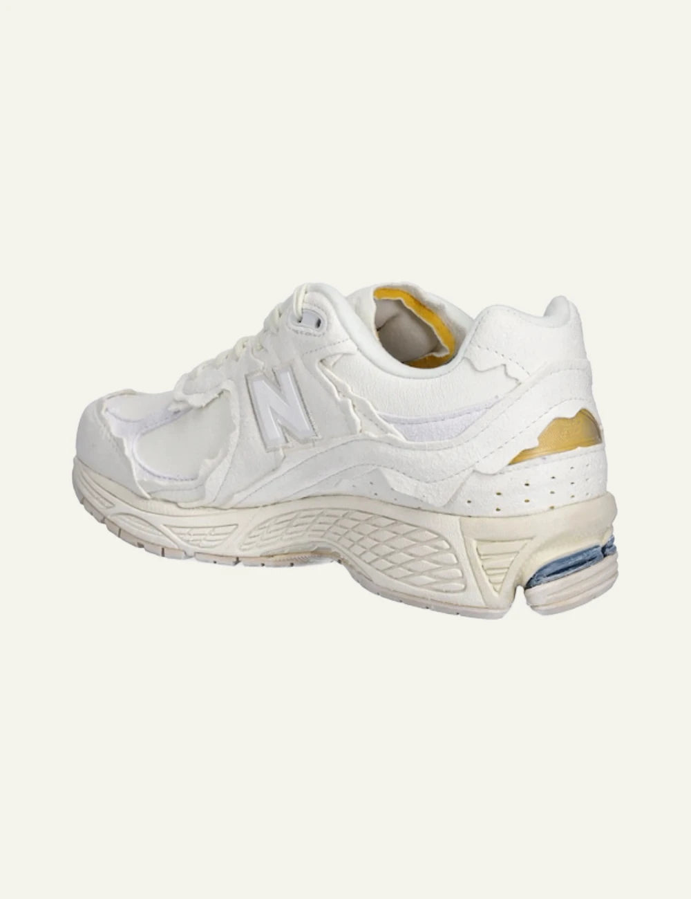 New Balance 2002R beige leather dad sneakers angled back view