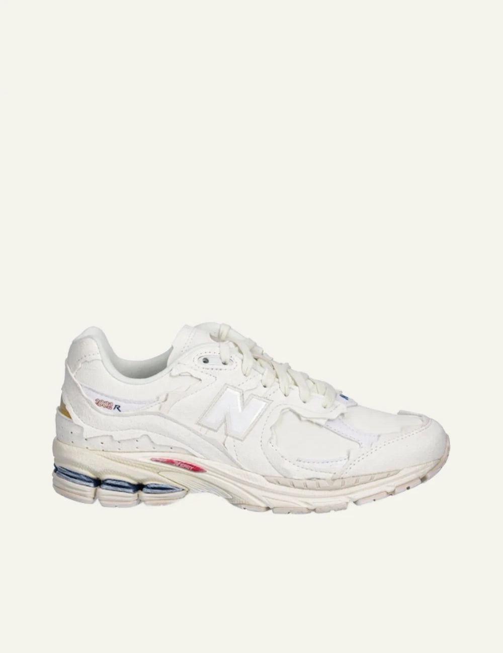 New Balance 2002R beige leather dad sneakers side view