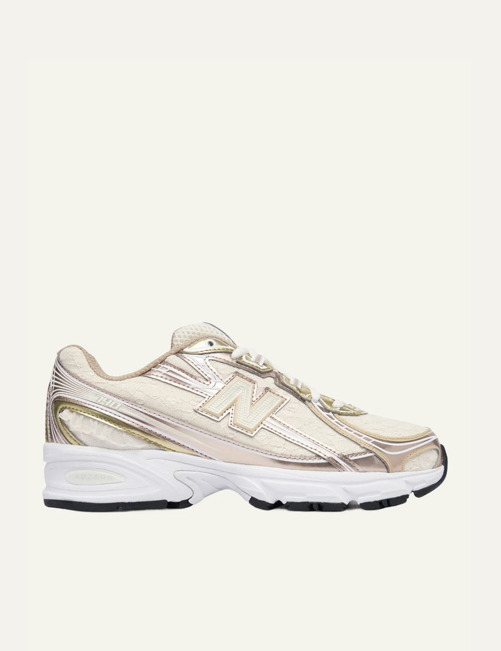 New Balance 740 women's beige sneakers with pink and gold metallic details side view
