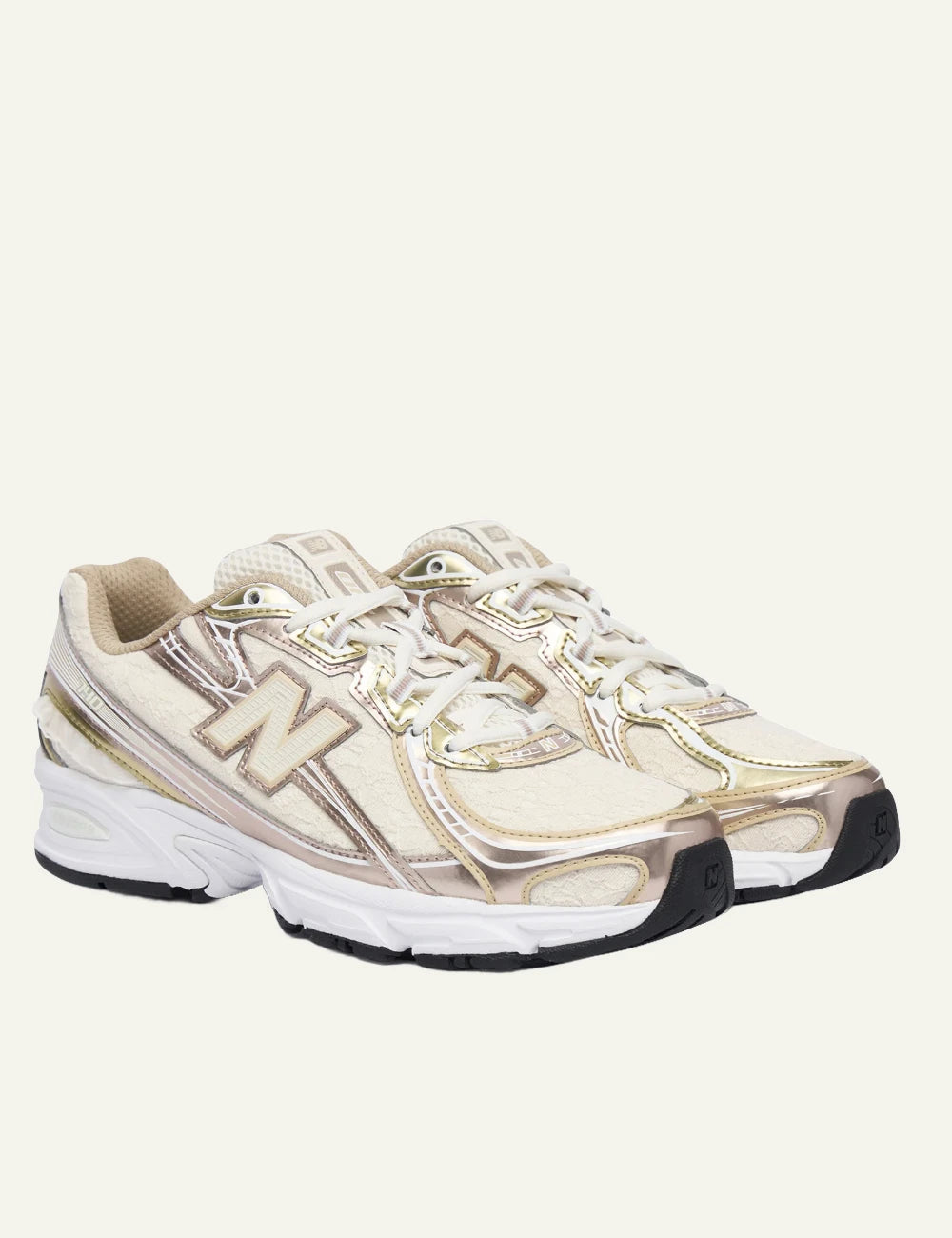New Balance 740 women's beige sneakers with pink and gold metallic details pair view