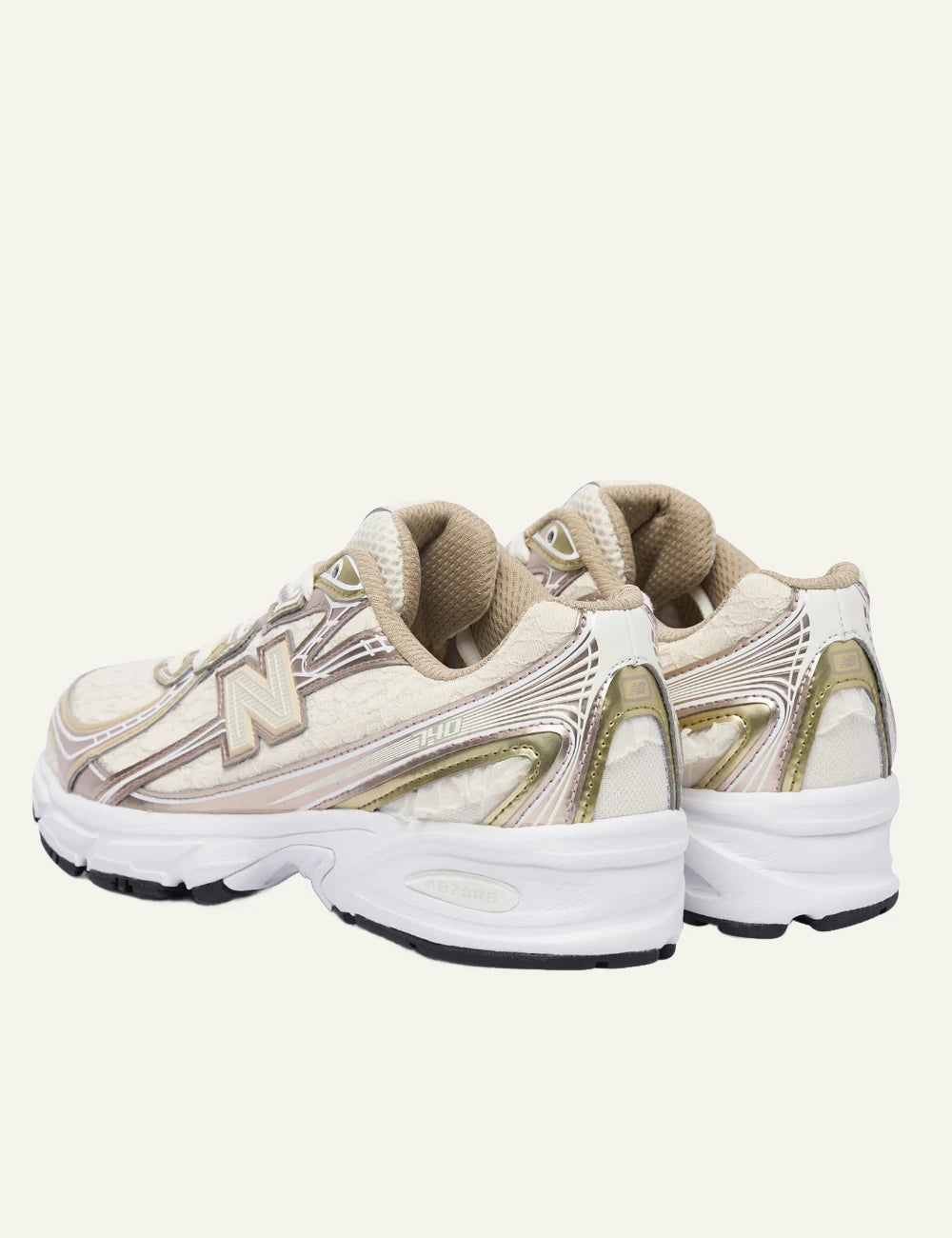 New Balance 740 women's beige sneakers with pink and gold metallic details back view