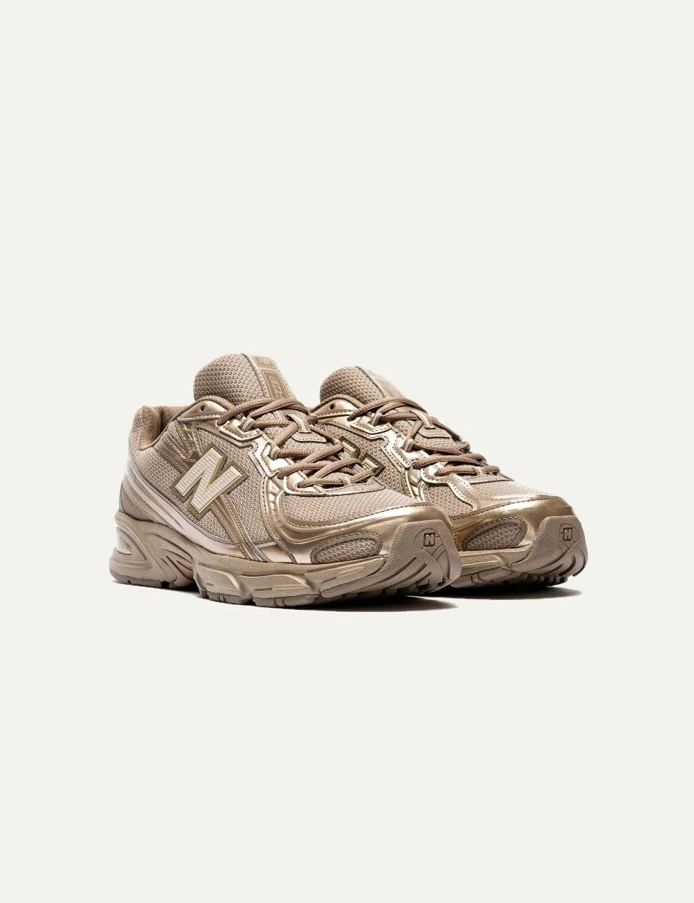New Balance women's mesh sneakers in brown with metallic details angled