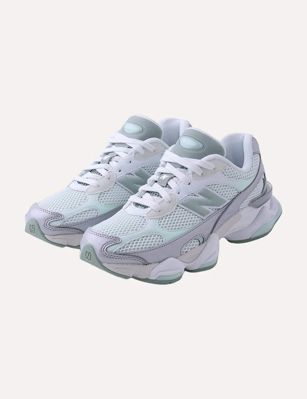 New Balance women's mesh sneakers in white with pastel green details angled