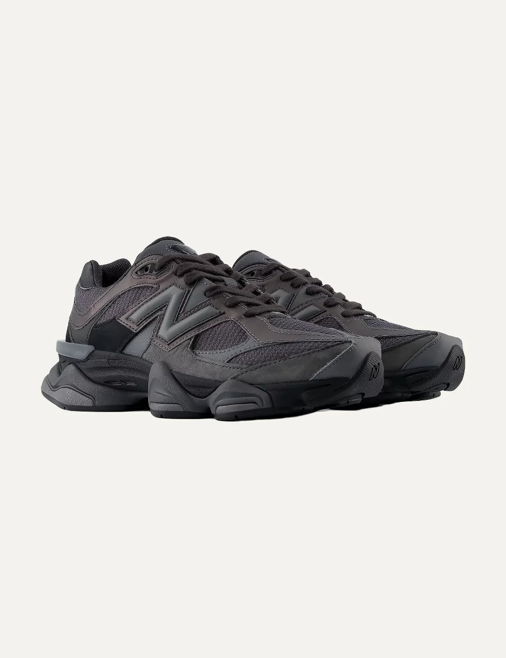 New Balance women's mesh and suede sneakers in dark grey and black angled