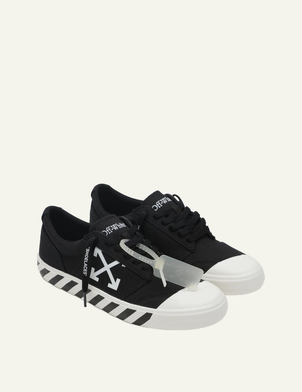 Off-White vulcanized sneakers black canvas arrows logo profile view