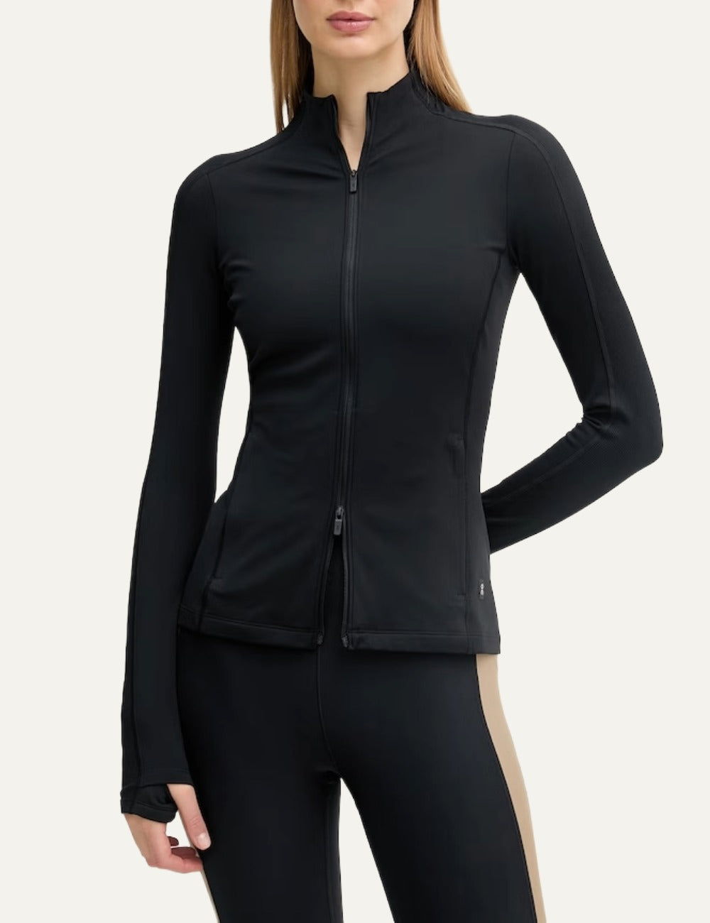 On black women's fitted zip-up sports jacket with fleece lining model