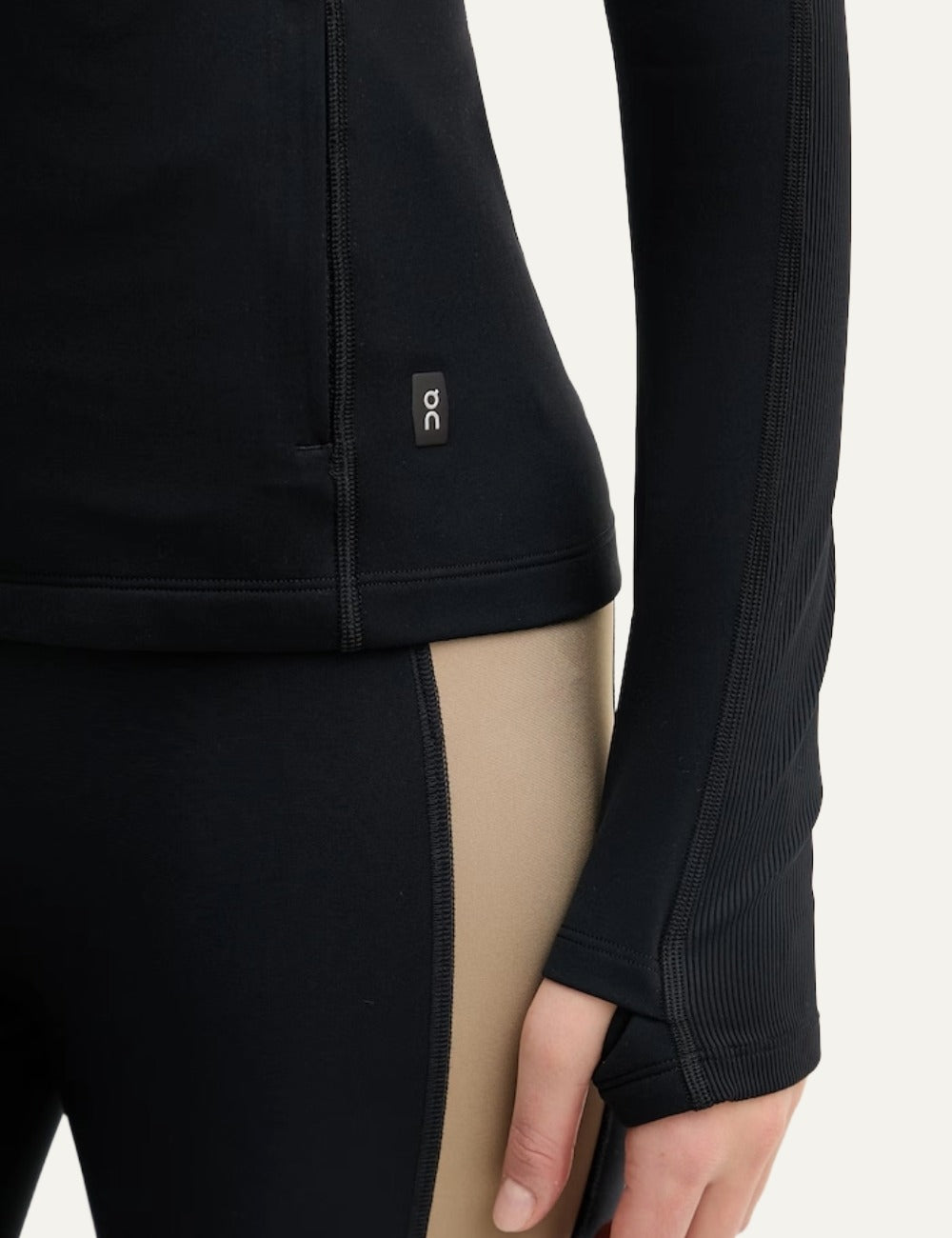 On black women's fitted zip-up sports jacket with fleece lining side detail