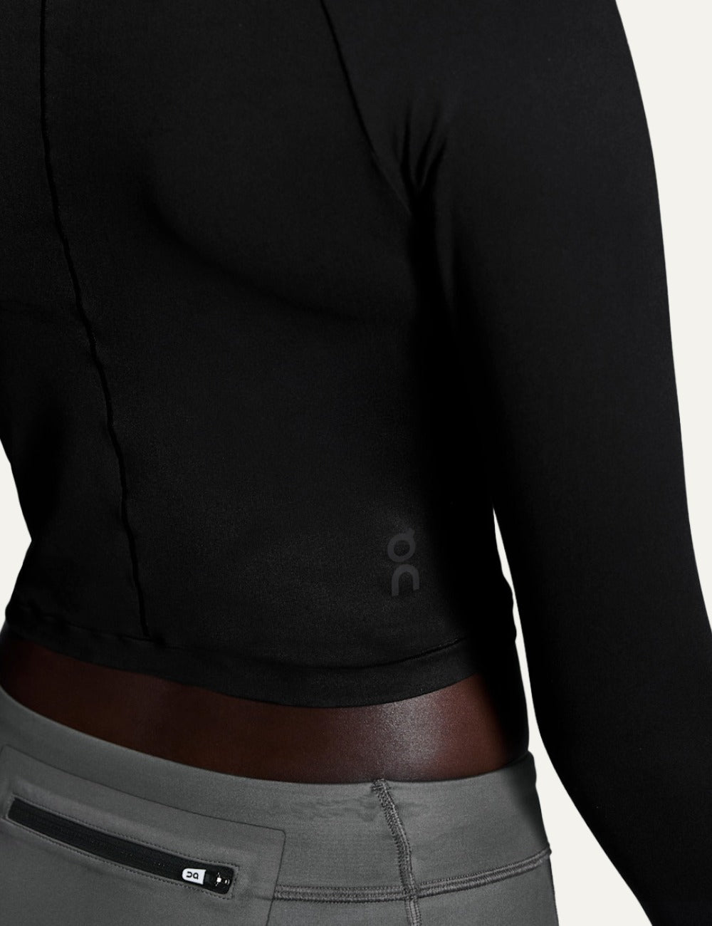 On black women's long sleeve crop training top detail