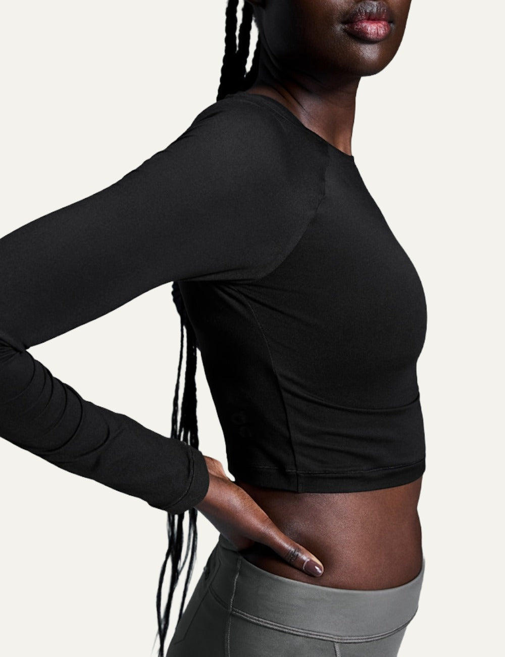 On black women's long sleeve crop training top side