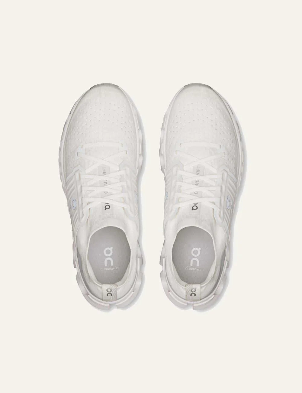 On men's white running sneakers with breathable mesh upper, grey details, CloudTec cushioning and Helion foam top