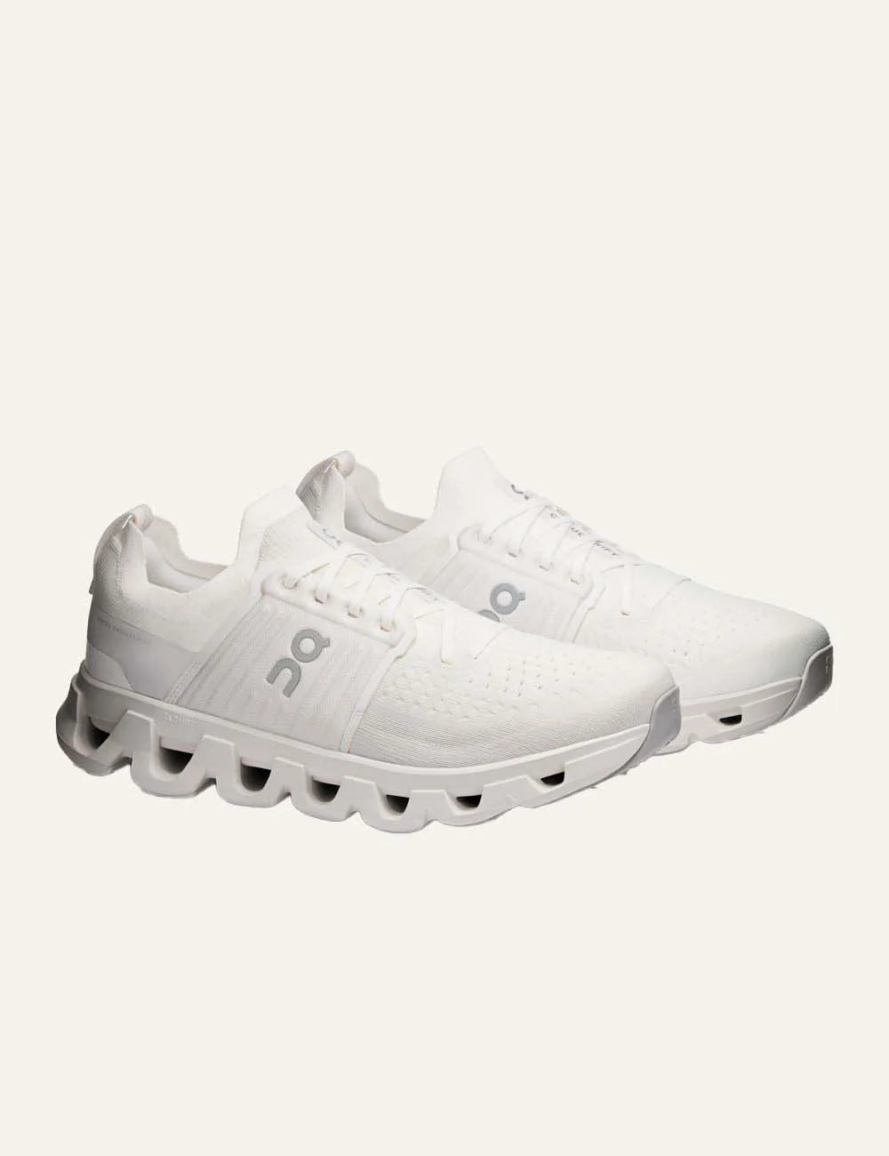 On men's white running sneakers with breathable mesh upper, grey details, CloudTec cushioning and Helion foam angled