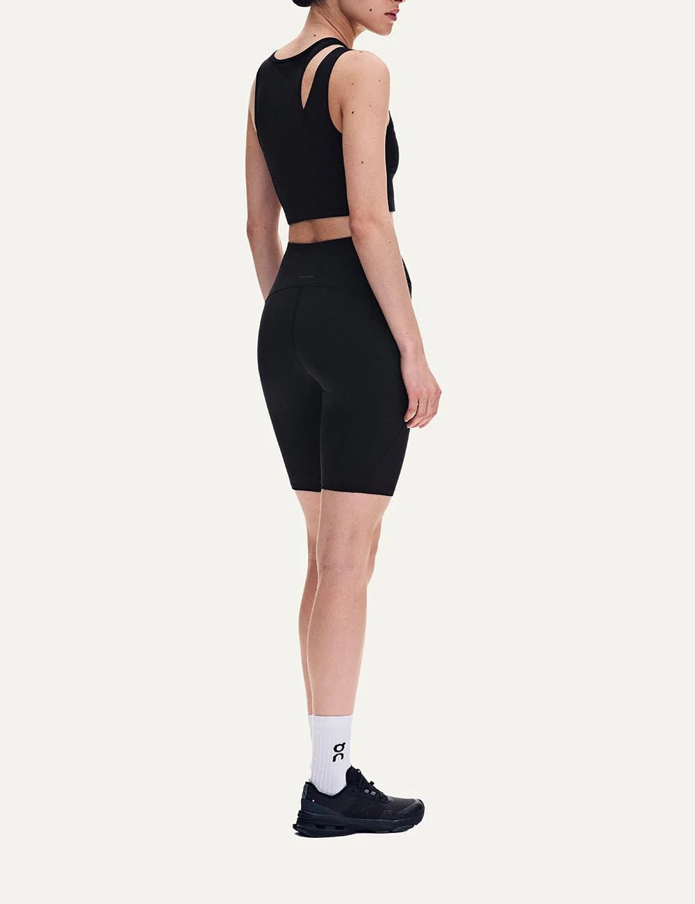 ON women's black asymmetric cropped training top with front cutout back