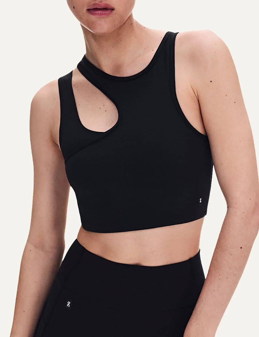 ON women's black asymmetric cropped training top with front cutout model