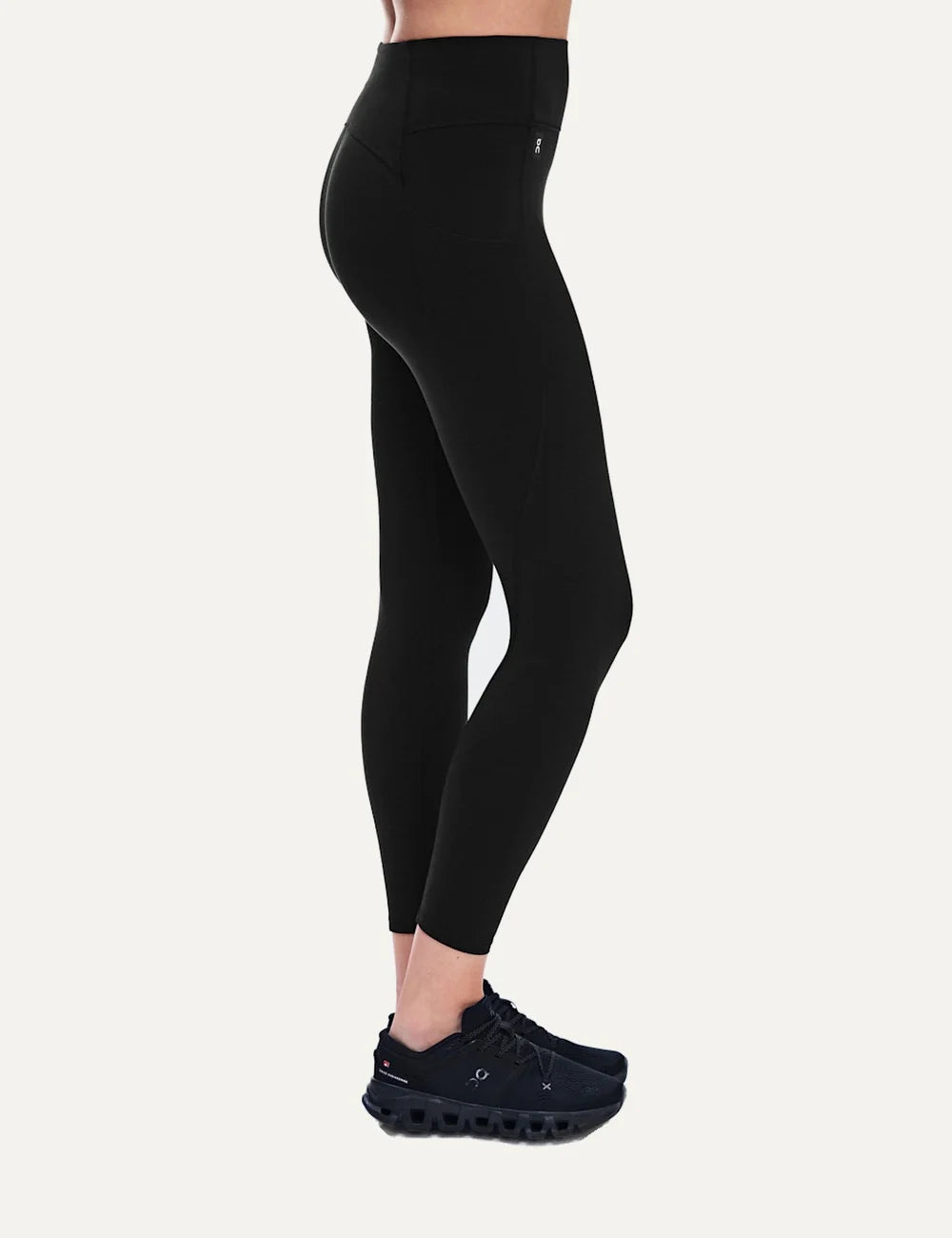 On women's black high-waisted athletic leggings with close fit, ankle length, soft SenseTec fabric, four-way stretch, seamless front and side phone pocket side