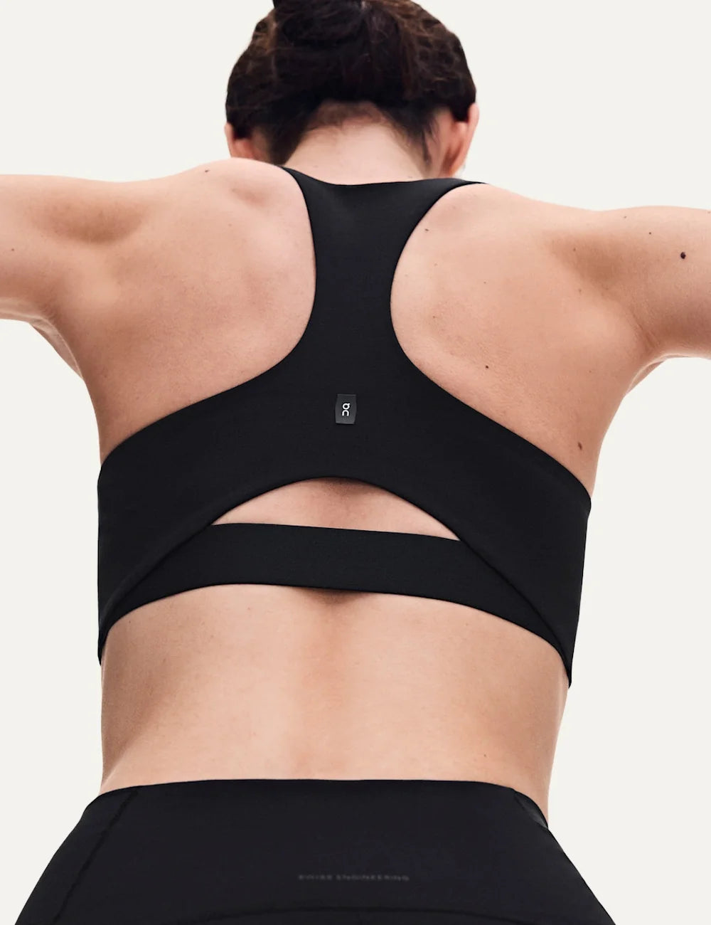 ON women's black racerback sports bra with soft stretch fabric back