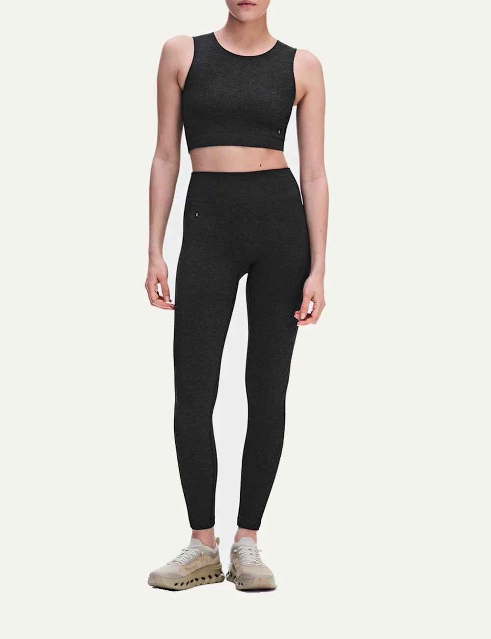On women's dark grey heathered crop athletic top with sleeveless design, round neckline, soft textured knit, four-way stretch fabric and bonded edges full body