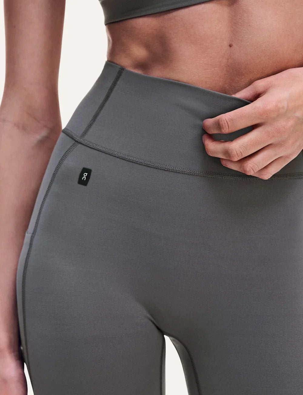 ON women's grey brown high-waisted 7/8 stretch training leggings front detail