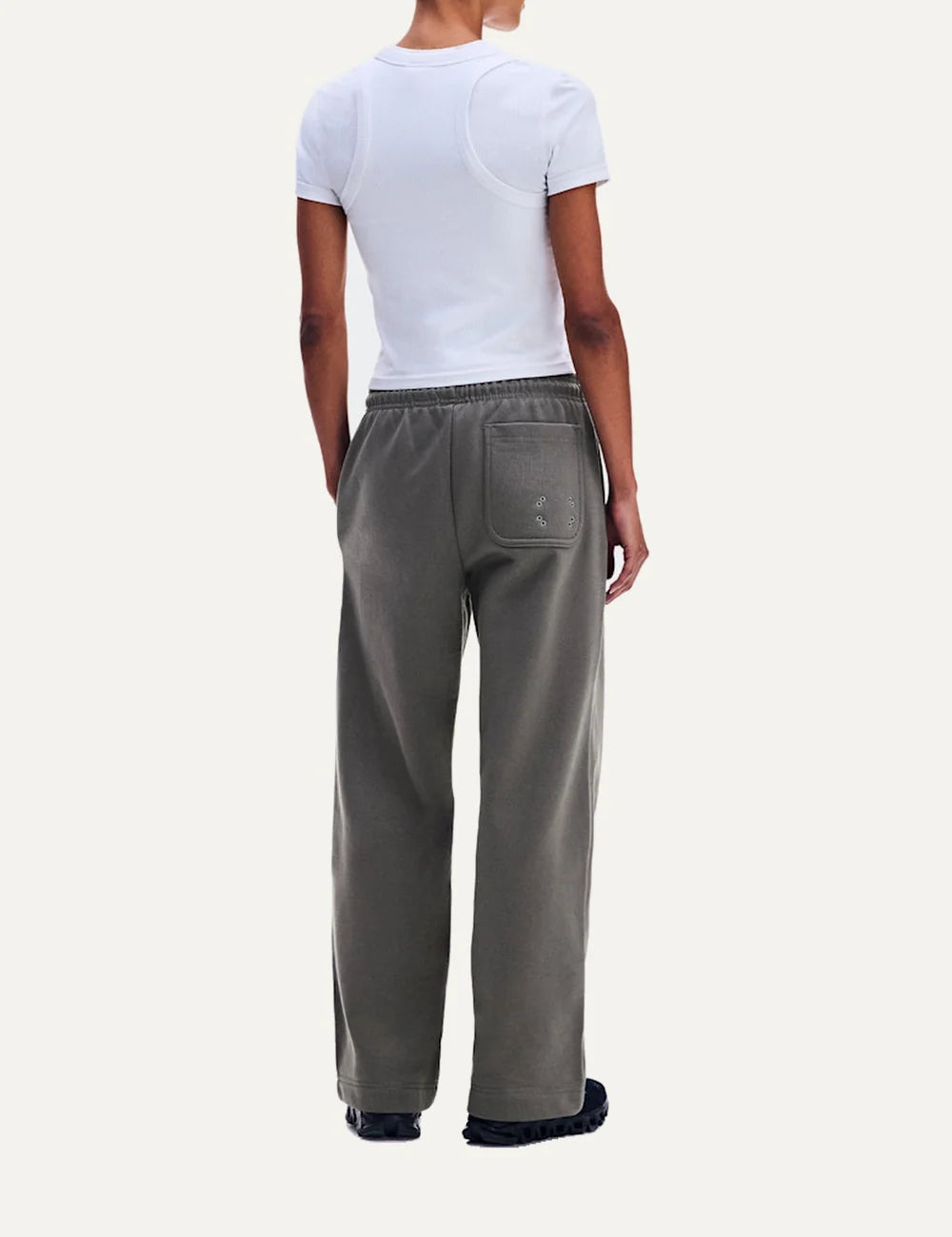 On women's grey relaxed fit sweatpants with wide straight legs, elastic drawstring waistband, soft brushed lining, side pockets and embroidered logos back