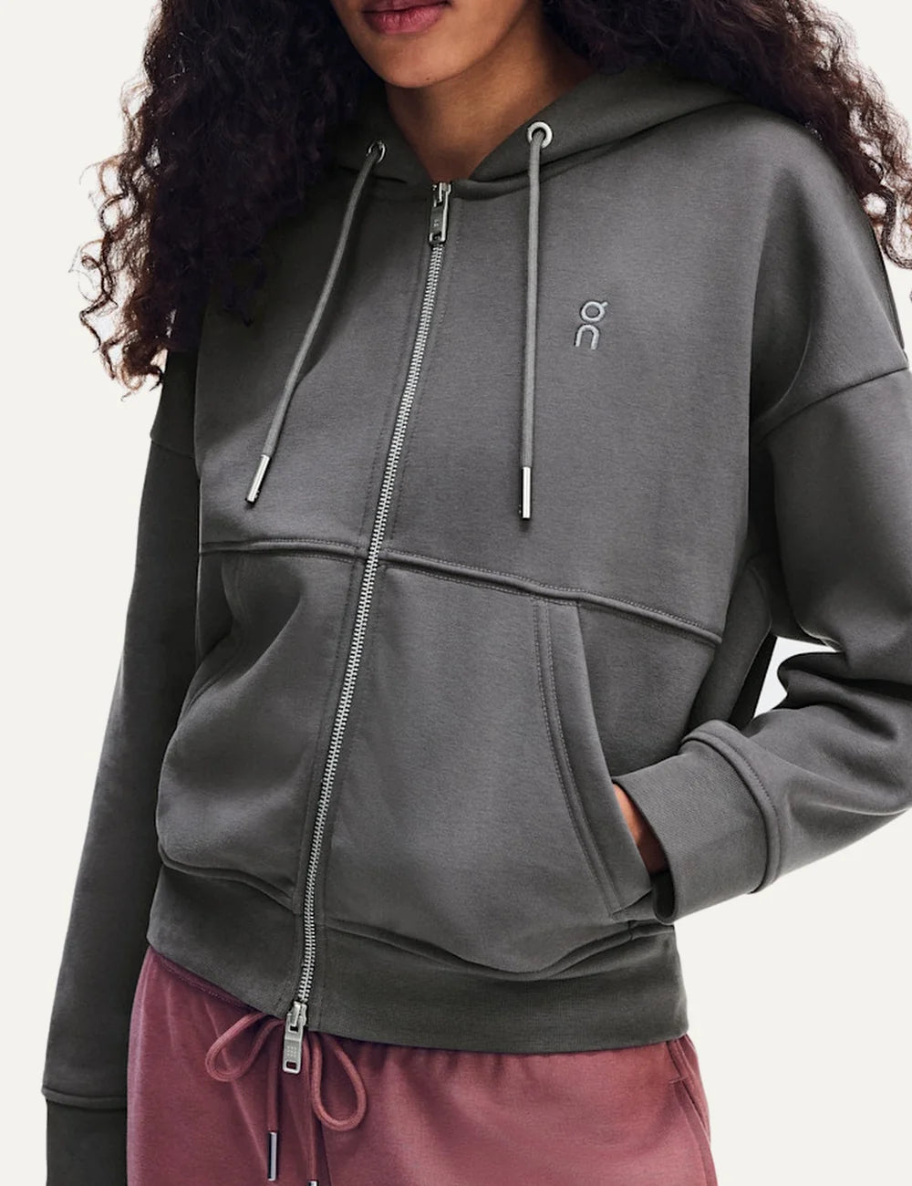 On women's grey zip-up hoodie with relaxed fit, drawstring hood, front pockets and embroidered logo.