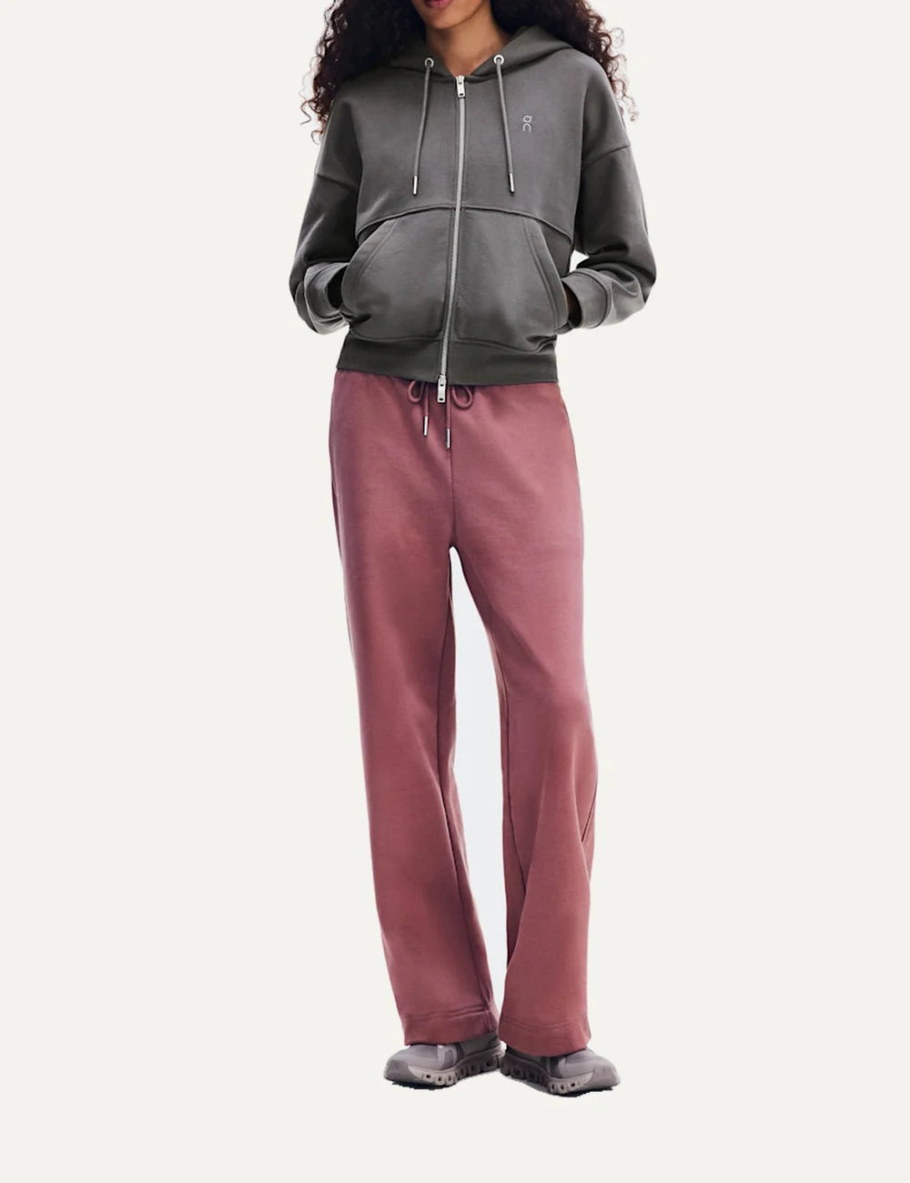On women's grey zip-up hoodie with relaxed fit, drawstring hood, front pockets and embroidered logo.
