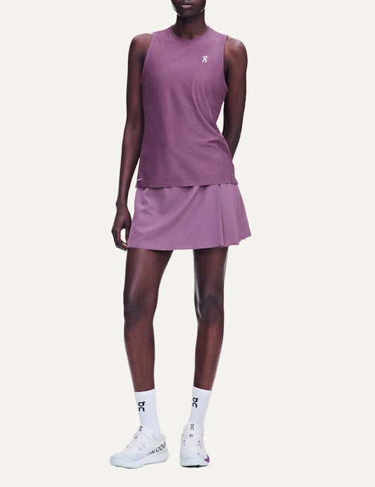 On women's purple pleated tennis skirt with integrated inner shorts