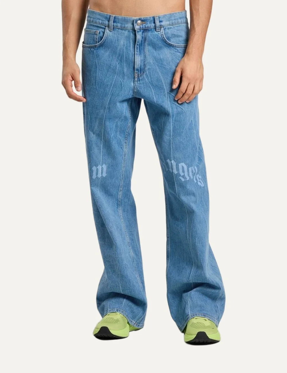 Palm Angels men's light blue washed loose fit jeans with wide straight legs, five-pocket design and split gothic Palm Angels logo across the front thighs model
