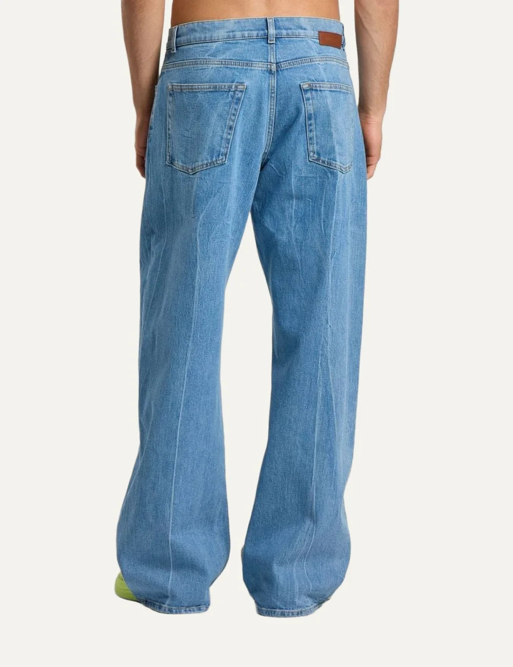 Palm Angels men's light blue washed loose fit jeans with wide straight legs, five-pocket design and split gothic Palm Angels logo across the front thighs back