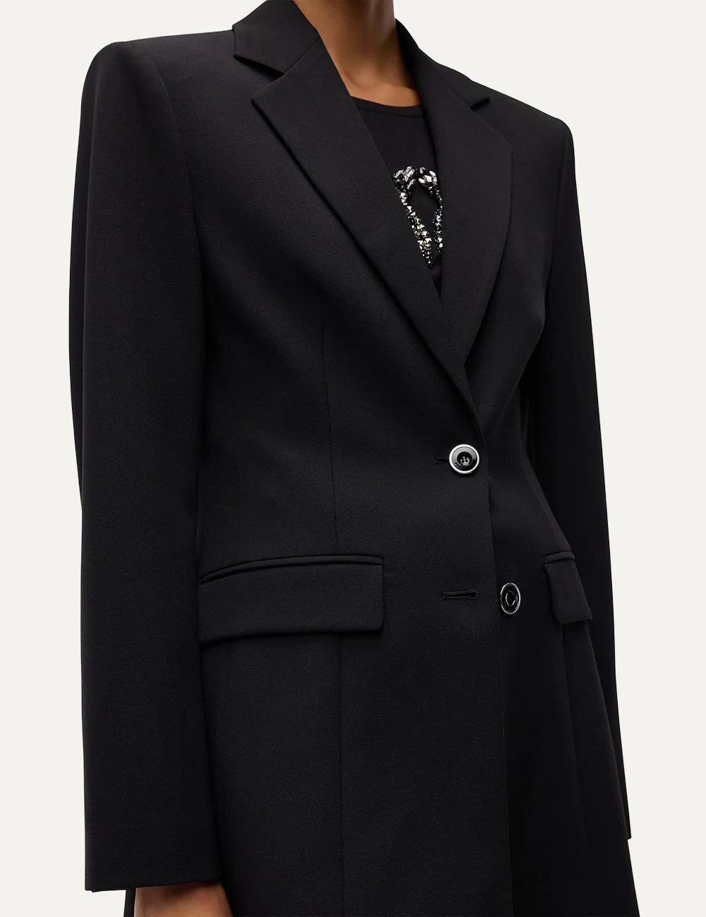 PINKO women's black tailored crepe blazer with structured shoulders, notched lapels, cinched waist and two-button closure close up view