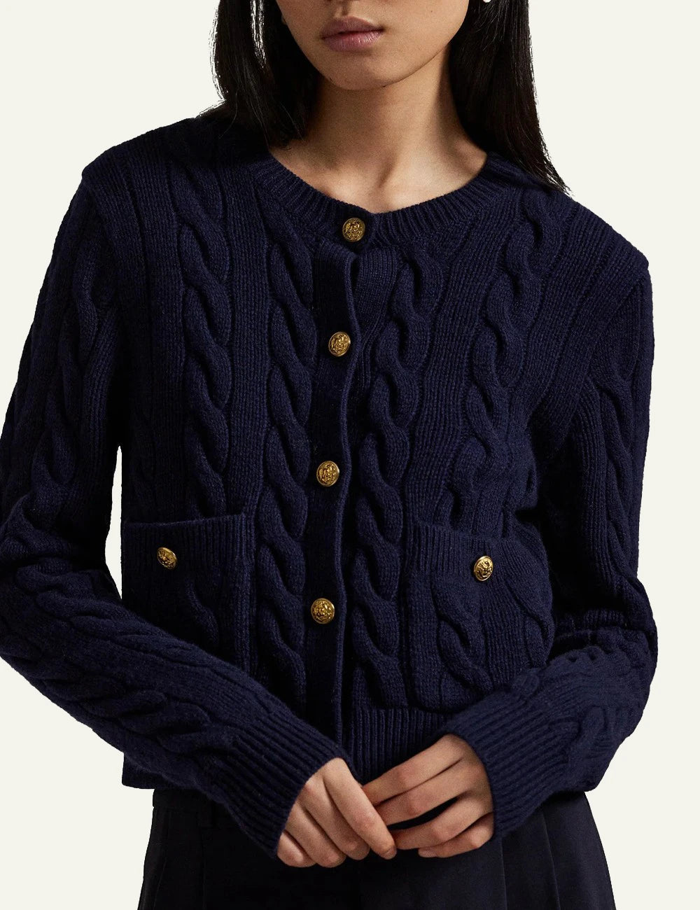 Women's Polo Ralph Lauren cable-knit cardigan in navy blue with gold-tone buttons and front pockets model