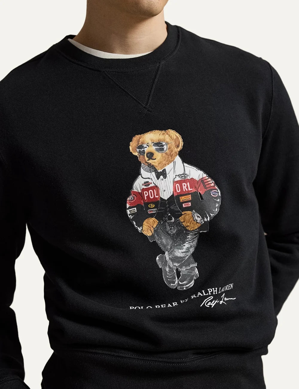 Polo Ralph Lauren men's black crewneck sweatshirt featuring a racing-inspired Polo Bear graphic, signature lettering, V-inset neckline and ribbed trims model